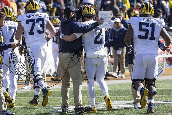 Tarik Black (7), Jalen Mayfield (73), Jim Harbaugh, Shea Patterson (2), and Cesar Ruiz (51)