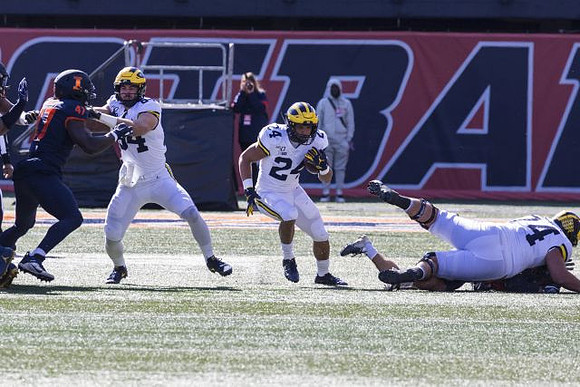 Sean McKeon (84), Zach Charbonnet (24), and Ben Bredeson (74)