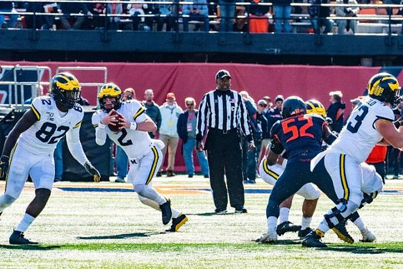 Nick Eubanks (82), Shea Patterson (2), and Jalen Mayfield (73)