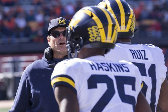 Jim Harbaugh, Hassan Haskins (25), and Cesar Ruiz (51)