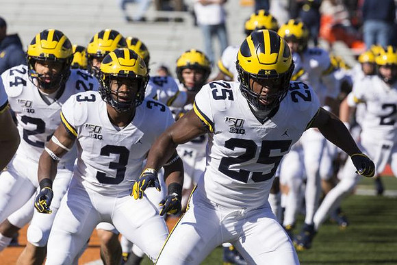 Zach Charbonnet (24), Christian Turner (3), and Hassan Haskins (25)