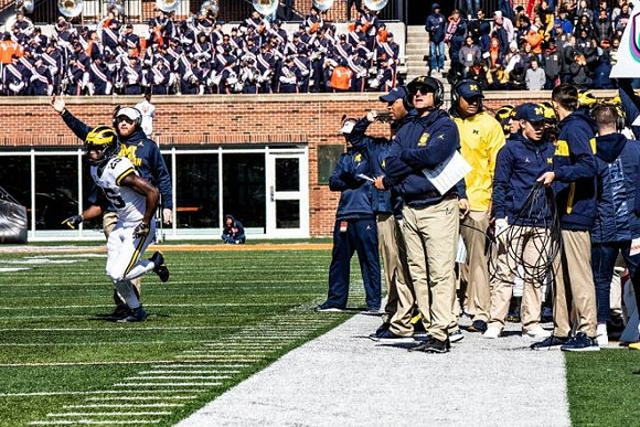 Hassan Haskins (25), Jay Harbaugh, and Jim Harbaugh
