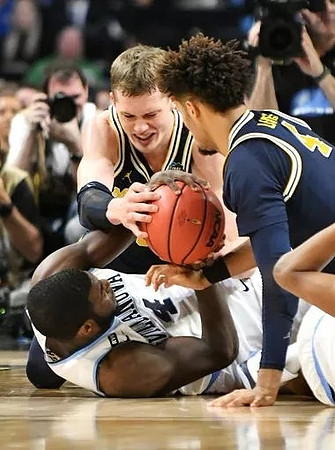 Moritz Wagner (13) and Isaiah Livers (4)