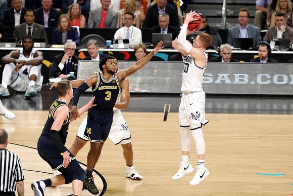 Moritz Wagner (13) and Zavier Simpson (3)