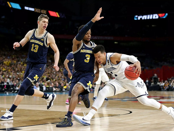 Moritz Wagner (13) and Zavier Simpson (3)
