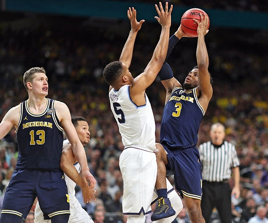 Moritz Wagner (13) and Zavier Simpson (3)