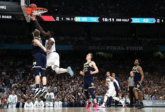 Moritz Wagner (13), Duncan Robinson (22), Zavier Simpson (3), and Villanova Head Coach Jay Wright