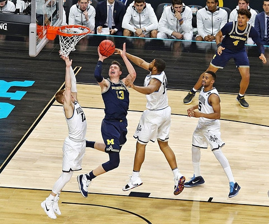 Moritz Wagner (13) and Isaiah Livers (4)