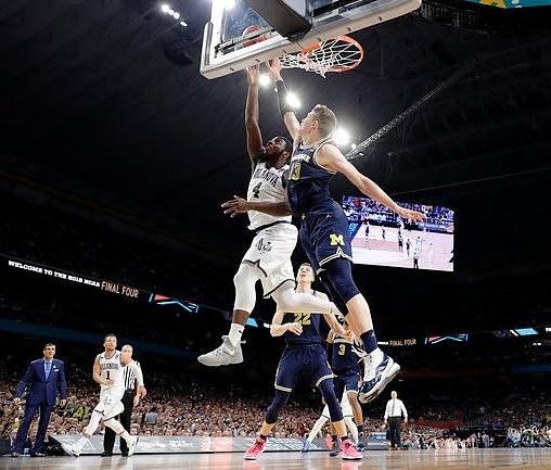 Villanova Head Coach Jay Wright, Moritz Wagner (13), Duncan Robinson (22), and Zavier Simpson (3)