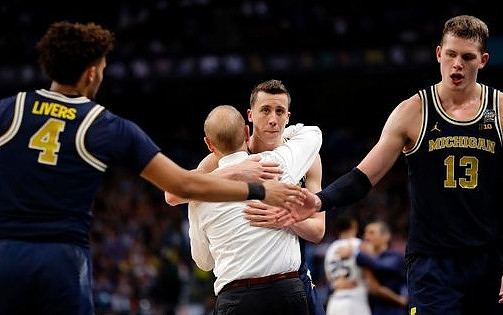 Isaiah Livers (4), John Beilein, Duncan Robinson (22), and Moritz Wagner (13)