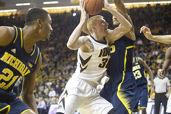 Zak Irvin (21), Jon Horford (15), and Caris LeVert (23)