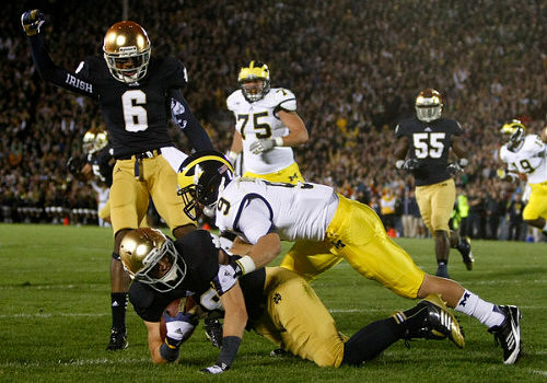 Michael Schofield (75), Drew Dileo (9), and Devin Funchess (19)
