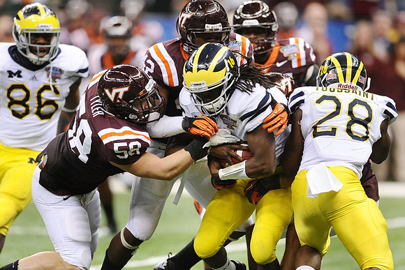 Kevin Koger (86), Denard Robinson (16), and Fitzgerald Toussaint (28)
