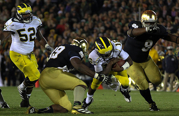 Ricky Barnum (52) and Denard Robinson (16)