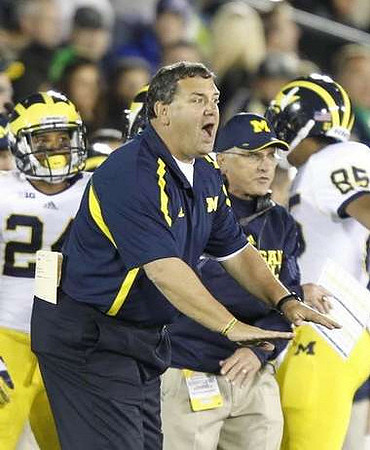 Delonte Hollowell (24), Brady Hoke, and Joe Reynolds (85)