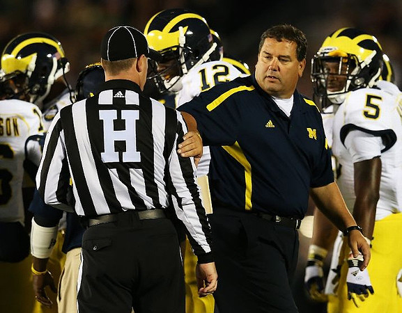 Denard Robinson (16), Devin Gardner (12), Brady Hoke, and Justice Hayes (5)