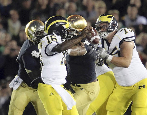Denard Robinson (16) and Michael Schofield (75)