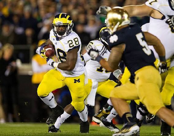 Fitzgerald Toussaint (28), Denard Robinson (16), and Taylor Lewan (77)