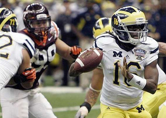 Mark Huyge (72) and Denard Robinson (16)
