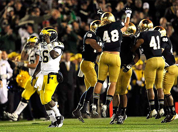 Michael Schofield (75) and Denard Robinson (16)