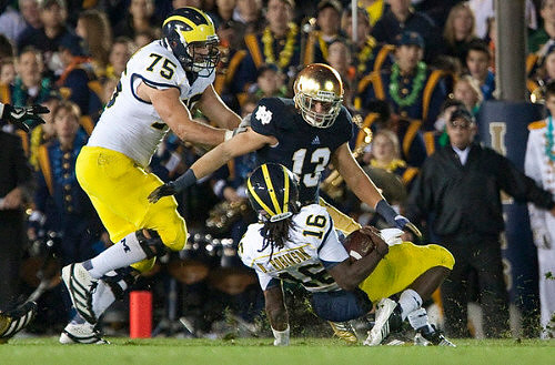Michael Schofield (75) and Denard Robinson (16)