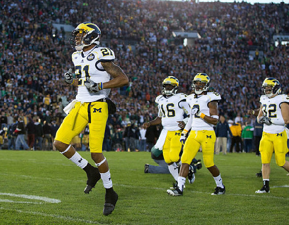Roy Roundtree (21), Denard Robinson (16), J.T. Floyd (8), and Jordan Kovacs (32)