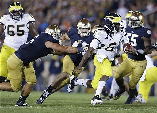 Patrick Omameh (65) and Denard Robinson (16)