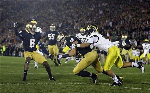 Drew Dileo (9), Elliott Mealer (57), and Denard Robinson (16)