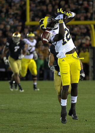 Taylor Lewan (77) and Devin Gardner (12)