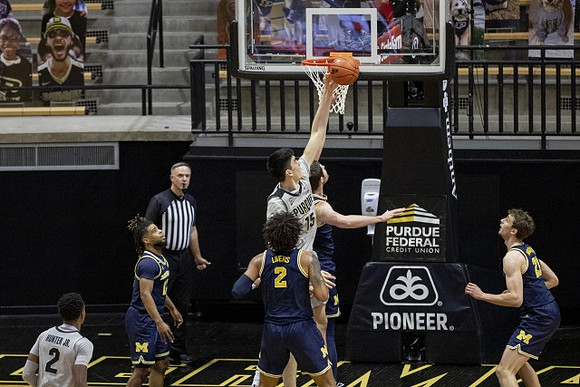 Mike Smith (12), Isaiah Livers (2), and Franz Wagner (21)