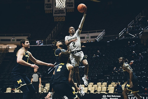 Hunter Dickinson (1), Isaiah Livers (2), Mike Smith (12), and Chaundee Brown Jr. (15)