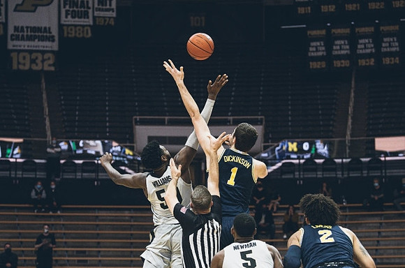Hunter Dickinson (1) and Isaiah Livers (2)