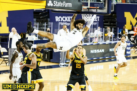 Chaundee Brown Jr. (15), Isaiah Livers (2), and Eli Brooks (55)