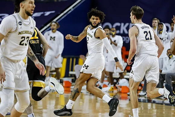Brandon Johns Jr. (23), Isaiah Livers (2), and Franz Wagner (21)