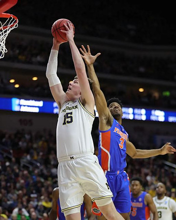 Jon Teske (15) and Zavier Simpson (3)