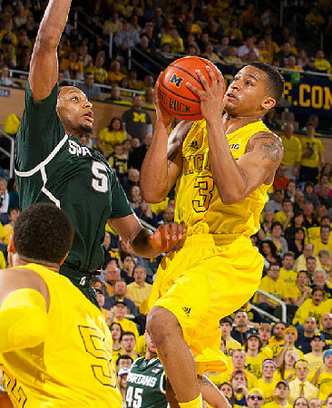 Jordan Morgan (52) and Trey Burke (3)