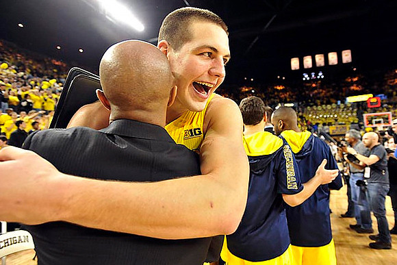 Mitch McGary (4), C.J. Lee, Josh Bartelstein (20), and Corey Person (32)