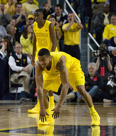 Trey Burke (3) and Caris LeVert (23)