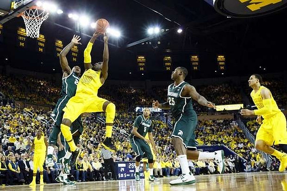 Caris LeVert (23) , Tim Hardaway Jr. (10), and Jordan Morgan (52)