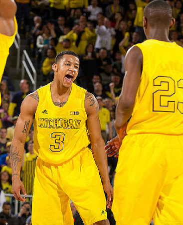 Trey Burke (3) and Caris LeVert (23)