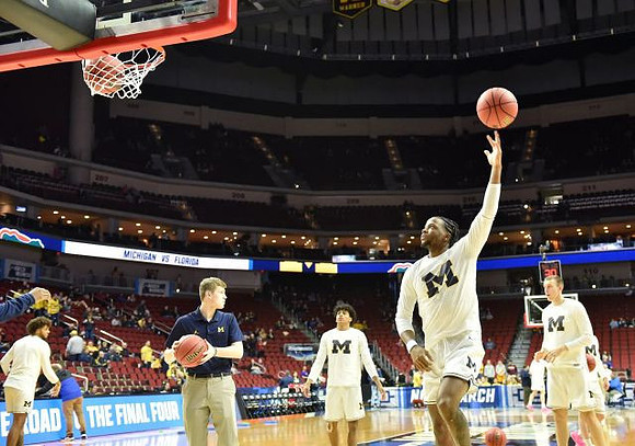 Isaiah Livers (4), Brandon Johns Jr. (23), Zavier Simpson (3), and Austin Davis (51)