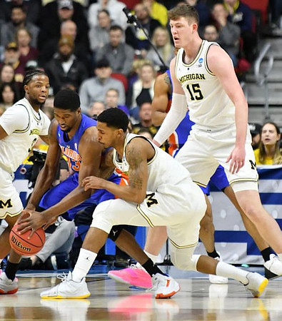 Zavier Simpson (3), Charles Matthews (1), and Jon Teske (15)