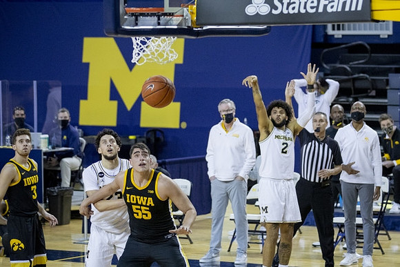 Brandon Johns Jr. (23), Isaiah Livers (2), and Iowa Head Coach Fran McCaffery