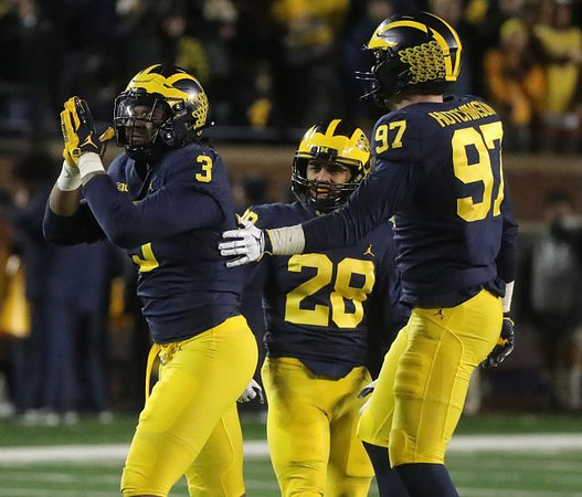 Rashan Gary (3), Brandon Watson (28), and Aidan Hutchinson (97)