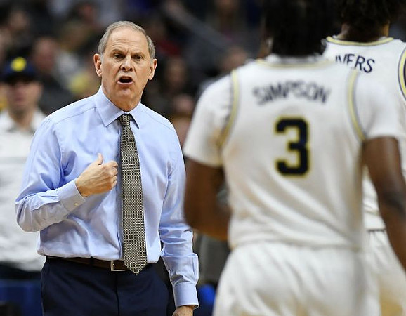 John Beilein, Zavier Simpson (3), and Isaiah Livers (4)