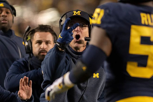 Jim Harbaugh and Cesar Ruiz (51)