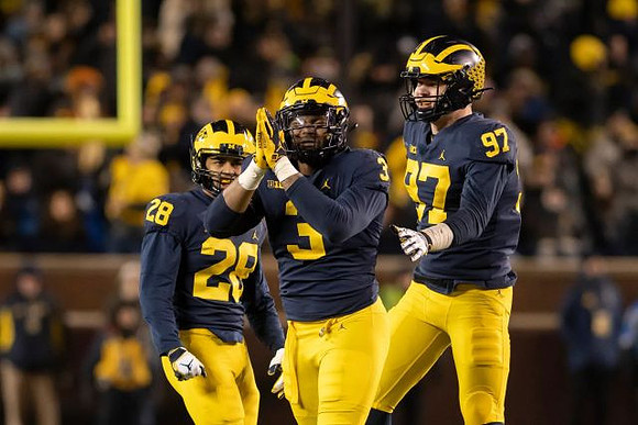 Brandon Watson (28), Rashan Gary (3), and Aidan Hutchinson (97)