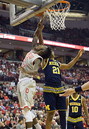Zak Irvin (21) and Derrick Walton Jr. (10)