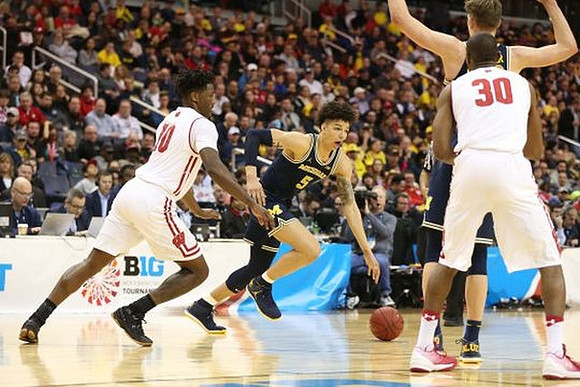 D.J. Wilson (5) and Moritz Wagner (13)