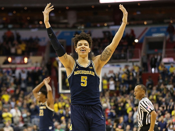 D.J. Wilson (5) and Zak Irvin (21)